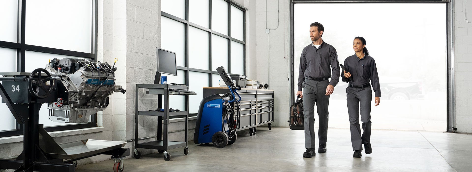 Two GM-certified technicians in a Buick and GMC service center serving Clinton Township, MI